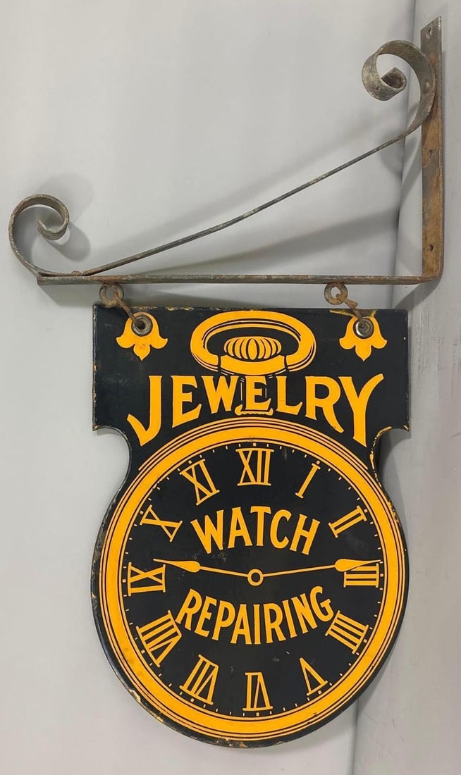 Jewelry Watch Repairing Porcelain Sign w/Bracket (TAC): rated 9, 15"x11.25", the DSP die-cut sign has excellent color and gloss with tiny chips around the perimeter. Rarity 3. TAC #032304