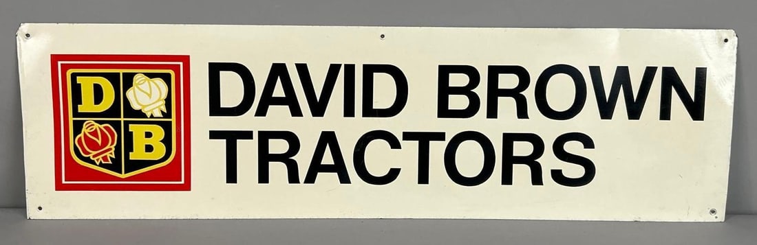 Dave Brown Tractors Tin Sign: (Rated 8.9). 7" x 24.5". This SST sign has good color and shine with minor surface scratching in the field, as well as, wear at the hanging hoes and on the outer edge. TAC # 062328.