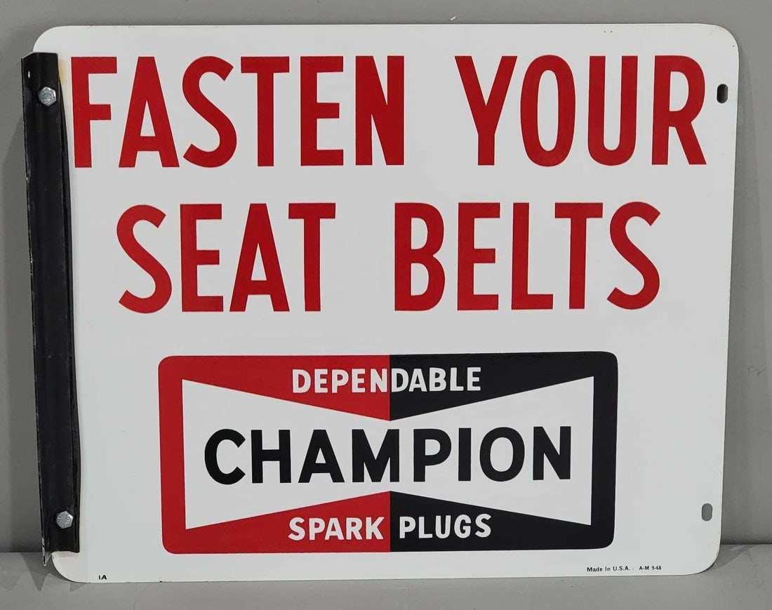 Champion Spark Plugs "Fasten Your Seat Belts" Metal Sign (TAC): rated 9, 14.5"x17.5", the DST sign has very good color and shine, light wear, marked A-M, dated 1968. Rarity 3. TAC #063297
