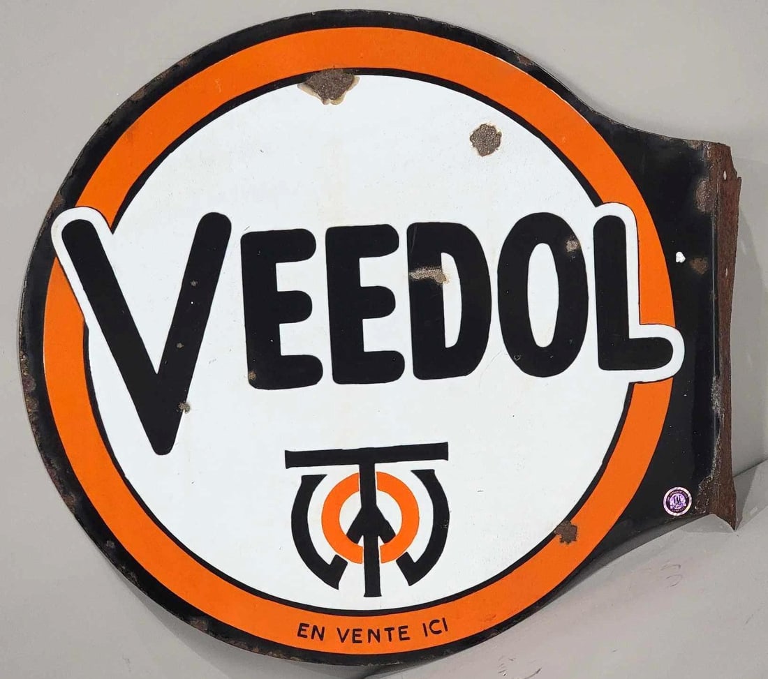 Veedol w/Logo Porcelain Flange Sign (TAC): rated 8, 21"x22", the die-cut porcelain flange sign has good color and gloss, has chips in the field, around the perimeter and on the flange. Rarity 3. TAC #063231