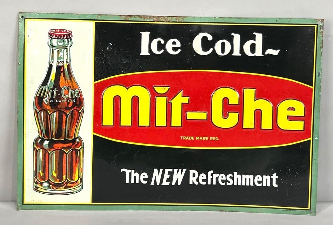 Mit-Che Soda Pop Embossed Tin Sign W/ Bottle Graphic: (Rated 8.0). 15.5" x 23.5". This SST sign has good color and shine with notable surface staining and deep scratches throughout the inner and outer fields. Outer edge also shows paint loss. Rarity 3.