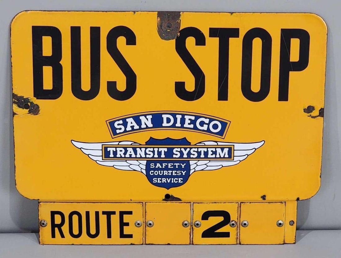 San Diego Bus Stop Route 2 Porcelain Sign (TAC): rated 8.25, 12.5'x16", the SSP diecut sign has good color and some gloss, has light wear in the field, has chips at mounting holes. Rarity 4. TAC #063287