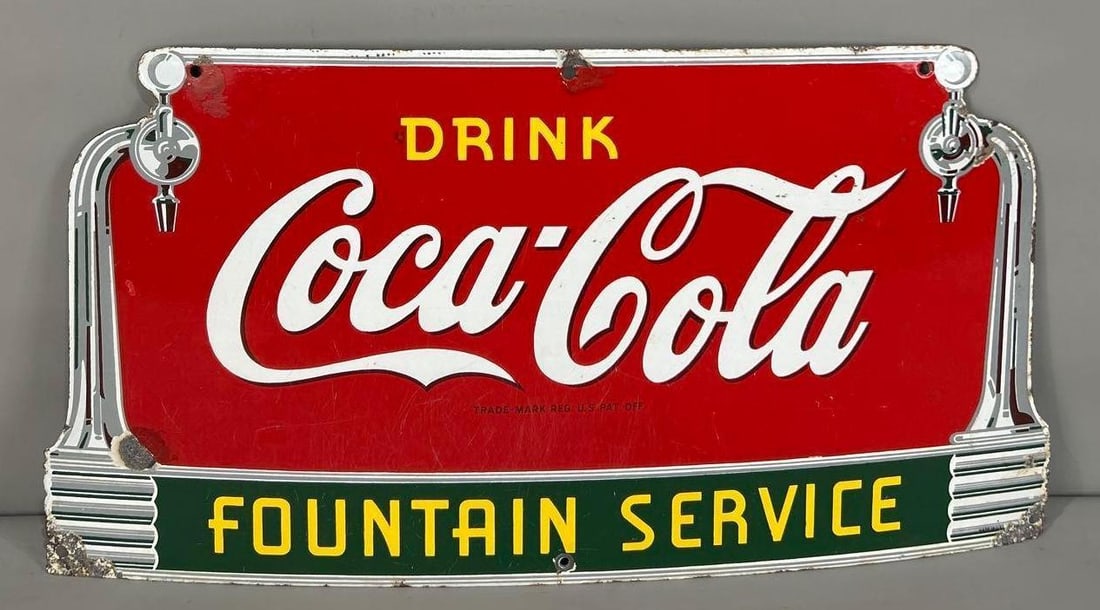 Drink Coca-Cola Fountain Service w/Spigots Porcelain Sign (TAC): rated 7, 14"x27", the SSP die-cut sign has good color and some gloss, has wear, scratches and chips, chips around the perimeter. Rarity 4. TAC #062771
