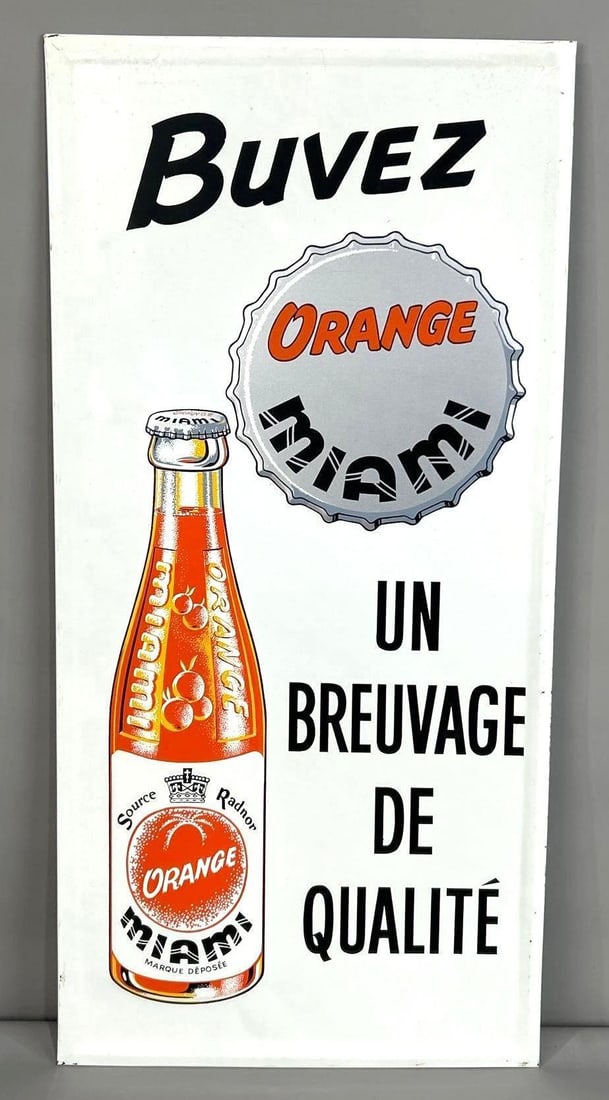 Miami Orange Soda Self-Framed Embossed Sign W/ Bottle & Cap Graphic: (Rated 9.0). 14" x 29.5". This SST sign has good color and gloss throughout with minor edge wear on the self-framed edge. marked, "STMS 63". Rarity 2. TAC # 062264