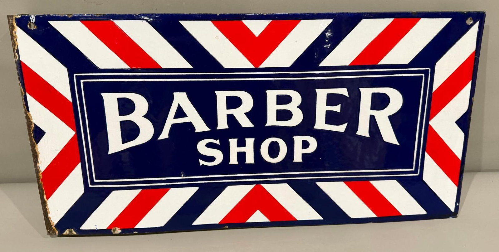 Barber Shop Porcelain Flange Sign (TAC): rated 9, 12"x24". The porcelain flange sign has excellent color and gloss, fields are clean. Sign has chips around the perimeter and larger ones on the flange. Rarity 2. TAC #061581