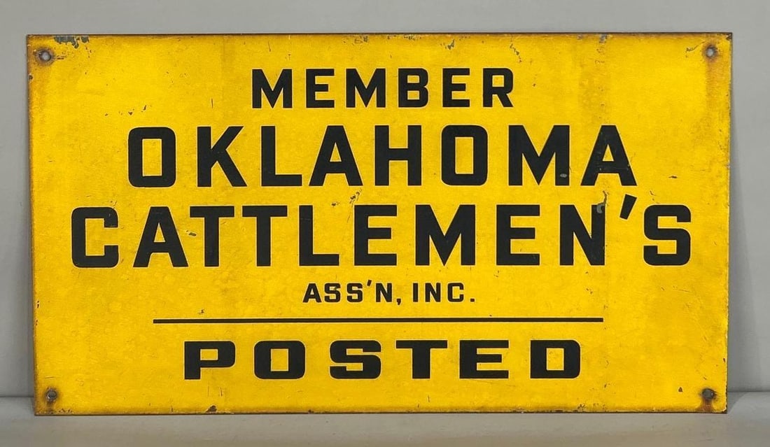 Oklahoma Cattleman"s Association Painted Metal Sign: (Rated 7.25). 10" x 18". This SST sign has deep scratches and fade throughout both fields and the outer edge. 