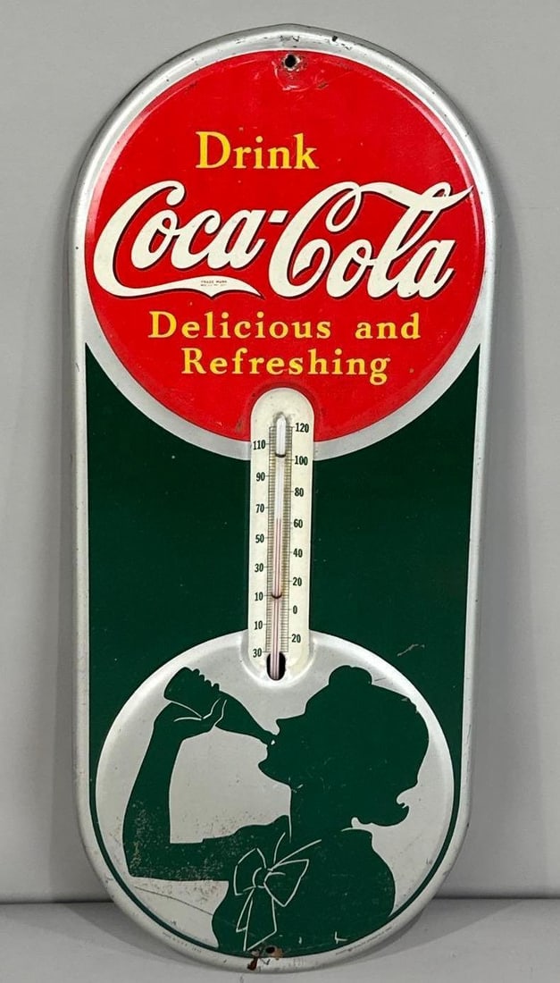 Drink Coca-Cola Tin Thermometer Sign W/ Female Silhouette Graphic: Rated 7.9. 6.5"x 16". This SST thermometer has good color and gloss with notable paint loss and scratching on the outer field, hanging holes and perimeter. Tube is working. Rarity 2. TAC # 062052.