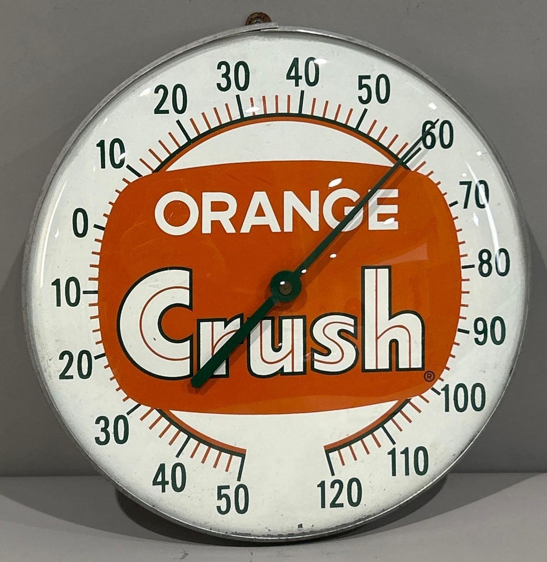 Orange Crush Thermometer: (Rated 8).12.5" dia. This thermometer has good color with light paint flake and staining on the edge of the face. Glass Face. Rarity 2. 