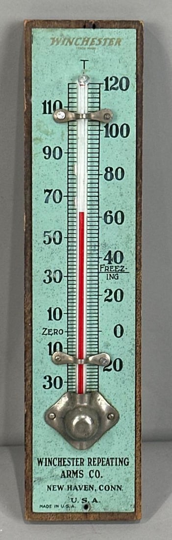 Winchester Repeating Arms Co. Thermometer Sign: Rated 8.9.1.75" x 7.5". This tin attached to wood backing thermometer has good color with minor pin point surface abrasions throughout the entirety of the piece. Working Tube. Rarity 8. TAC # 033865&n
