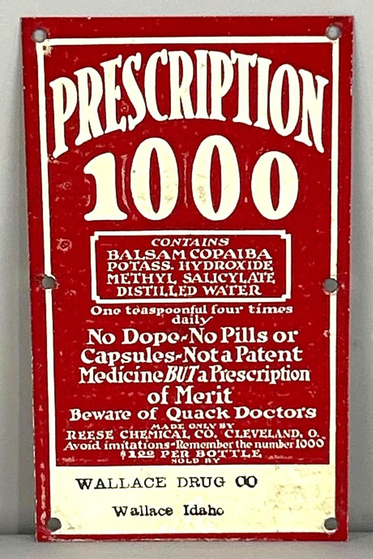 Prescription 1000 Tin Sign W/ Wallace Idaho Stamp: Rated 8.25. 4" x 6.5" This SST sign has good color and gloss throughout with minor surface abrasions in both the inner and outer fields. Sign has slight edge wear. Rarity 5. TAC # 061898.
