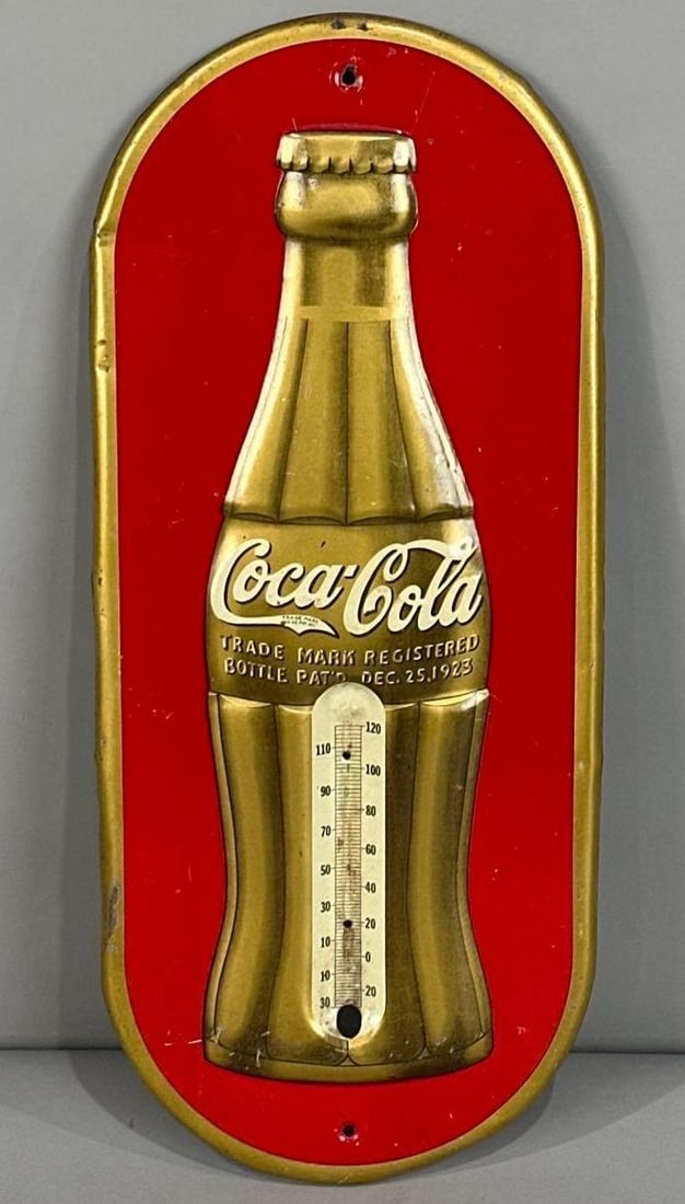 Coca-Cola Embossed Tin Thermometer Sign W/ Golden Bottle Graphic.: Rated 8.5. 7" x 16". This SST thermometer has good color and gloss with notable staining and scratching on both fields. Outer edge also shows staining and paint loss. Tube missing. Rarity 2. TAC # 062