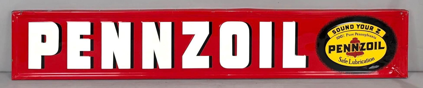 Pennzoil w/Sound Your Z Logo Metal Sign (TAC): rated 8.75, 12"x70", the SST embossed wood-backed sign has excellent color and shine, field is clean, has creases at the right-hand end, marked A-M, dated 1949. Rarity 5. TAC #063667