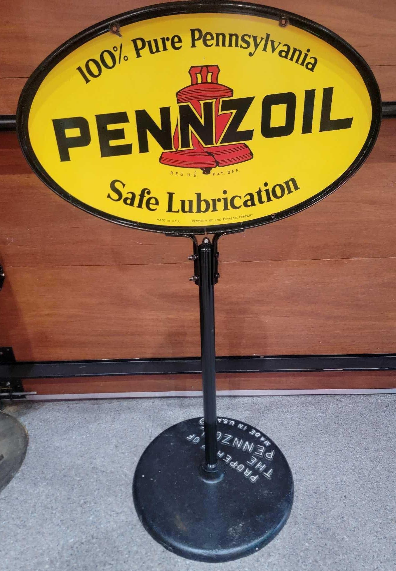 Pennzoil "Safe Lubrication" w/Red Bell Logo Porcelain Curb Sign (TAC): rated 8.75, 18"x31", the DSP oval sign has excellent color and gloss, has tiny chips on both sides, mounted on original cast iron base. Rarity 4. TAC #036827