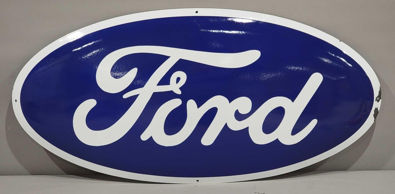 Ford Oval Porcelain Sign: rated 9, 19.25"x39.25", the SSP domed oval sign has good color and gloss, field is clean, has chips around the perimeter. Age is unknown on this piece.