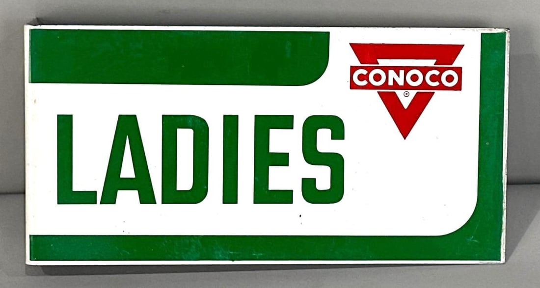 Conoco Ladies Room Flange Sign W/ Logo Graphic: Rated 8.9, 8.9. 5" x 10". This DST flange sign has good color with surface staining and scratches throughout both fields. Reverse side shows rice paper staining in the green. Rarity 2. TAC # 062068.