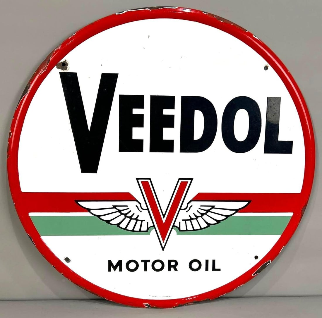 Veedol Motor Oil 24" Porcelain Sign W/ Green Band Logo: (Rated 8.5) 23.5" dia. This SSP sign has good color and shine throughout both fields. Sign shows light staining on both fields, as well as, porcelain loss on the hanging holes and self-framed edge. Ma
