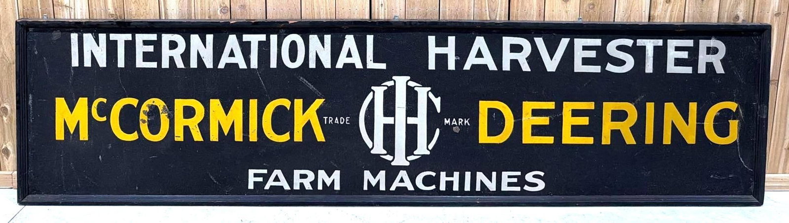 Large International Harvester McCormick Deering Smaltz Painted Sign (TAC): rated 8.5, 29.5"x120", the SST Smaltz painted wood framed sign, the Smaltz is excellent condition, has extra hole in the center, has a few extra holes in the "O" in McCormick, other light wear and one