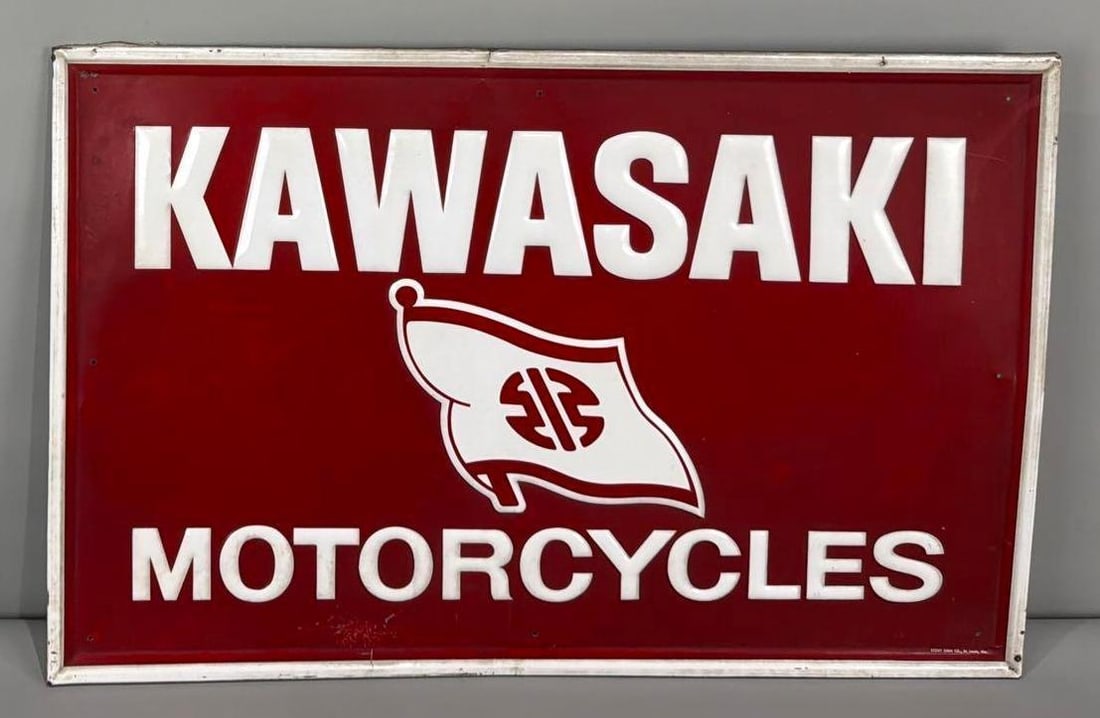Kawasaki Motorcycle w/Flag Metal Sign (TAC): rated 8.25, 22"x34", the SST embossed sign has good color and some shine, has minor cease and wear in the field, marked Stout. Rarity 8. TAC #063660