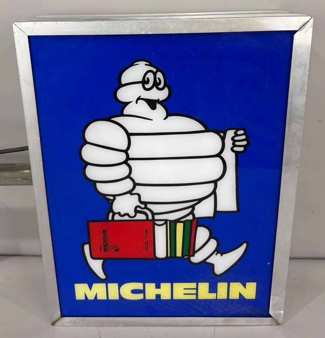 Michelin w/Bibendum Carrying Service Books Lighted Plastic Sign: rated 9, 22"x17"x6", the 2-flat plastic inserts are in very good condition, mounted in a metal light box flange mounted, needs to be rewired, is setup of European wiring now.