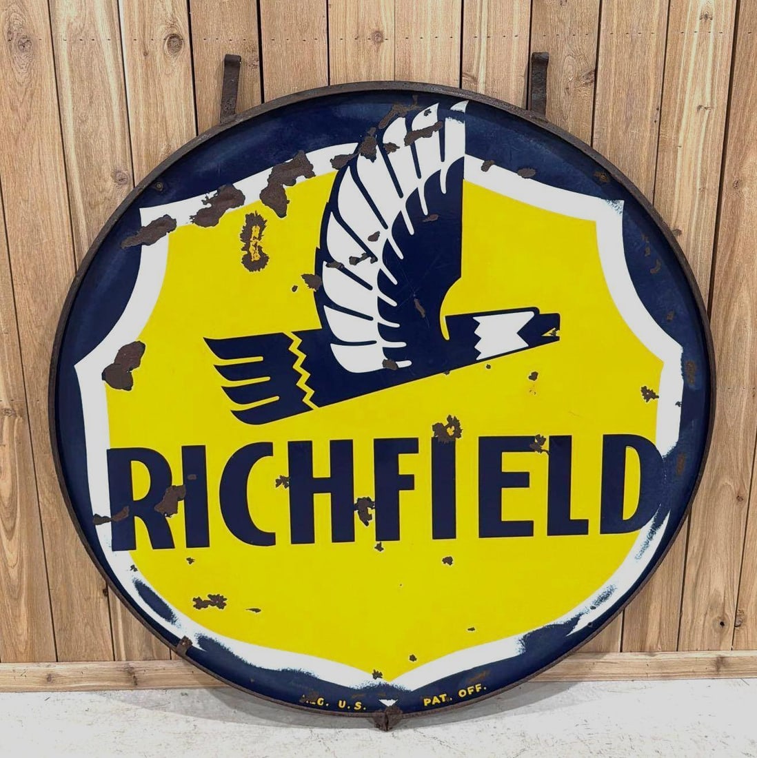 Richfield w/Art Deco Eagle Porcelain ID Sign (TAC): rated 7.5, 60"D., the DSP sign has good color and some gloss, has several large chips in the fields, mounted in metal ring. Rarity 4. TAC #063858