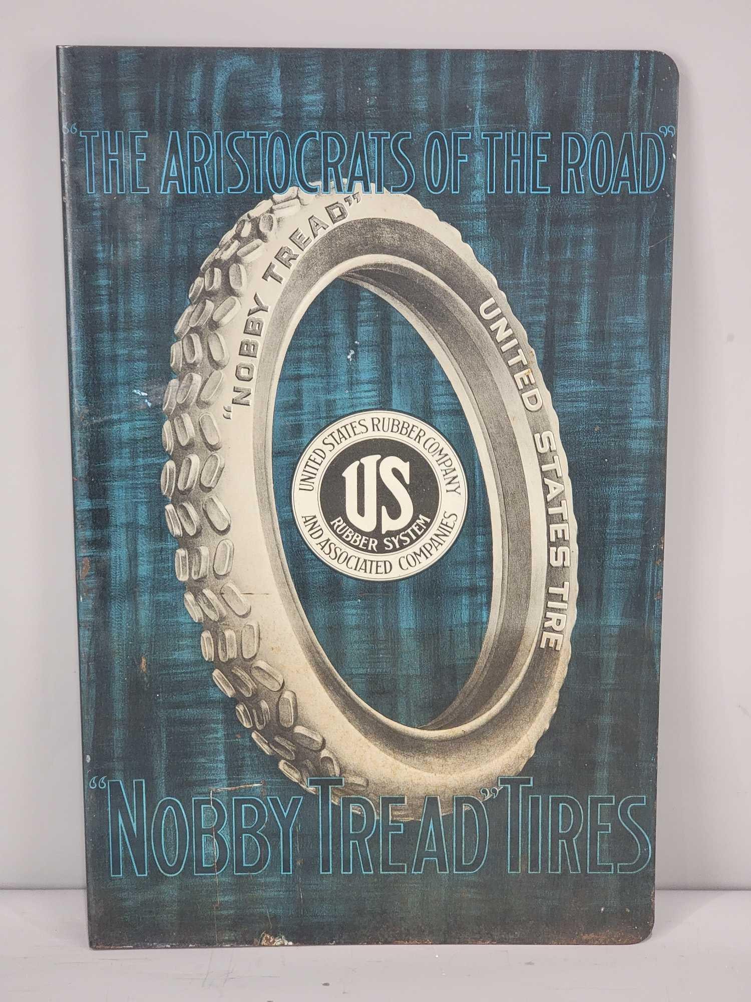 United States Tire "Nobby Tread" Metal Flange Sign (TAC): rated 8.5 & 8.25, 19.5"x12.5", the metal flange has good color and shine, display has light wear and minor staining in the lower field, reverse has the staining coming up higher, marked American Art W