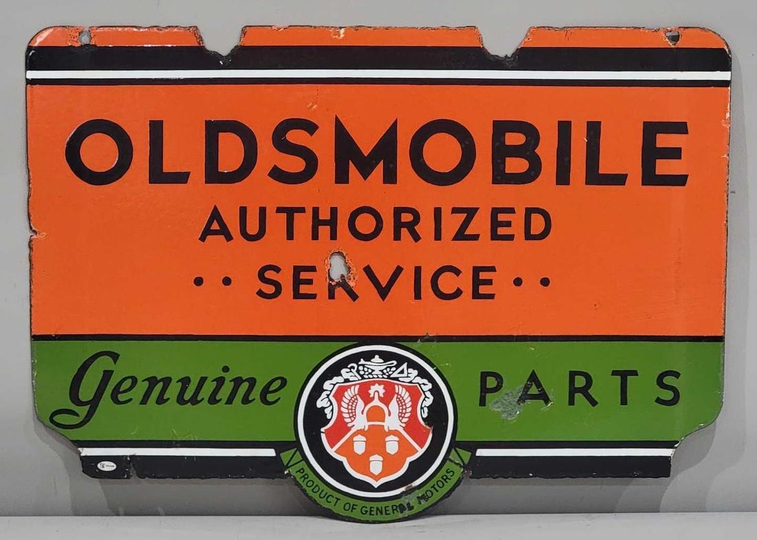 Oldsmobile Authorized Service Genuine Parts w/Logo Porcelain Sign (TAC): rated 7, 20"x28", the DSP die-cut sign has good color and gloss, has hole in the field, metal loss at mounting holes, chips around the perimeter. Rarity 7. TAC #032447
