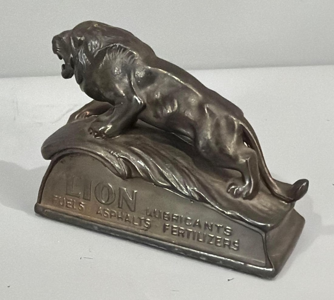 Lion Oil Company Metal Paper Weight: rated 9.5, 2.75"x4"x1.5", the metal paper weight is in very good condition.