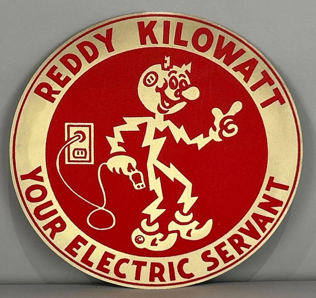 Ready Kilowat Reflective Sign W/ Reddy Kilowat Graphic: Rated 9.0. 8" dia. This single sided aluminum sign has good color with notable staining on the outer edge. Rarity 5. TAC #062048