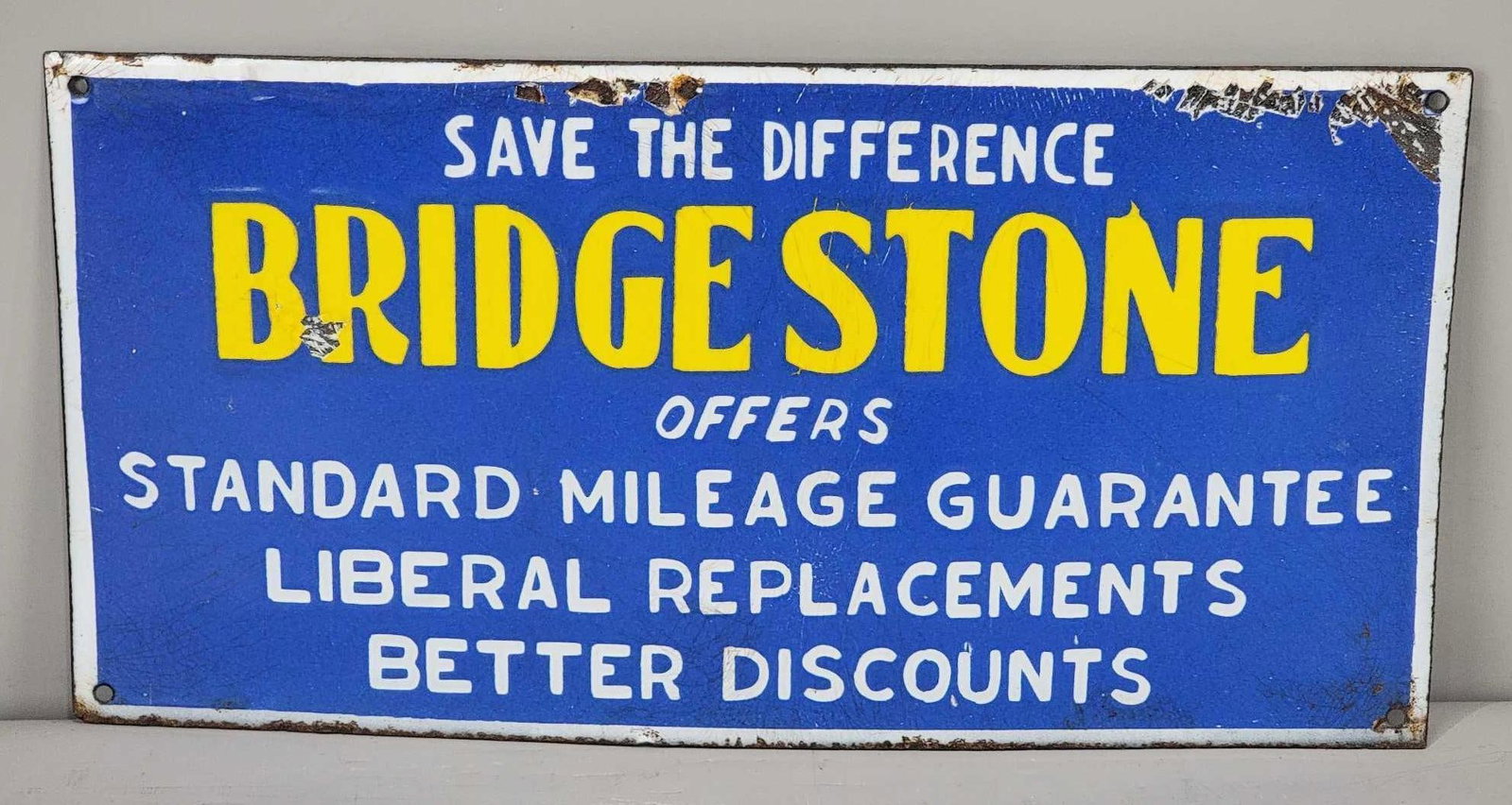 Bridgestone (tires) Save The Difference Sign (TAC): rated 8.25, 6"x12", the SSP sign has good color and gloss, has chips in the field and along the top edge. TAC #063873