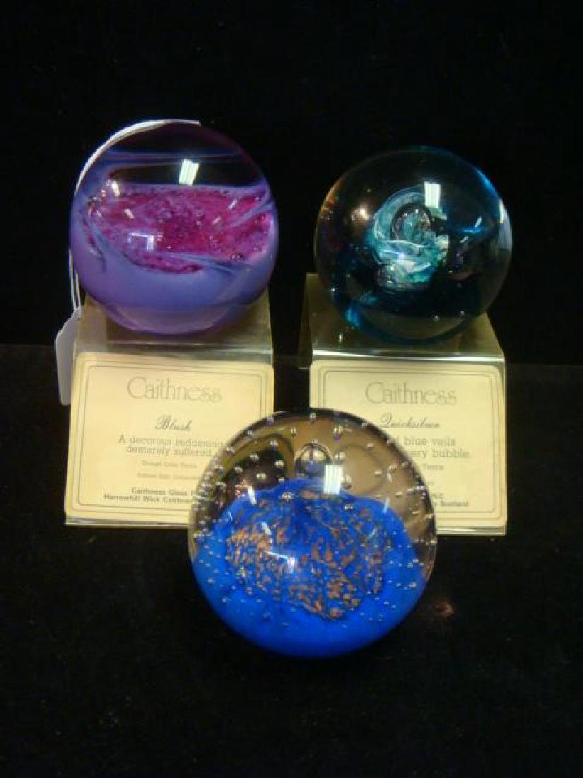 Three CAITHNESS Glass Paperweights with Two Stands:: Three CAITHNESS Glass Paperweights with Two Stands: "Quicksilver", Ribbed Blue Veils Cradle a Silvery Bubble. "Blush", A Decorous Reddening Demurely Suffered. Both Designed by Colin Terris. "Starlight