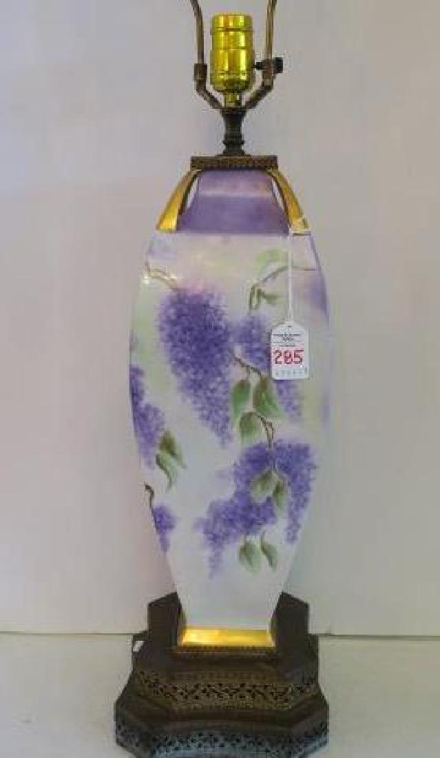 Hand Painted Porcelain Table Lamp with Fringed Shade:: Hand Painted Porcelain Table Lamp with Fringed Shade: Vase Shaped Porcelain Body with Hand Painted Lilacs on Pierced Metal Double Plinth is 19"T. Newer Fringed Silk Shade is 22"T. (100-200)
