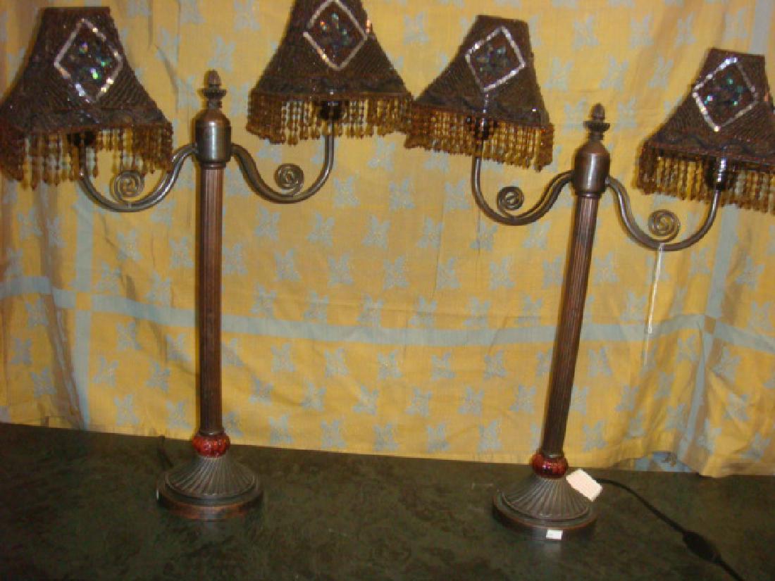 Pair of Beaded Shade Double Light Lamps:: Pair of Beaded Shade Double Light Lamps: Reeded Metal Columns with Amethyst Glass at Top of Foot. Double Scroll Arms half Beaded Mesh Shades with Bead Fringe. (140-260)
