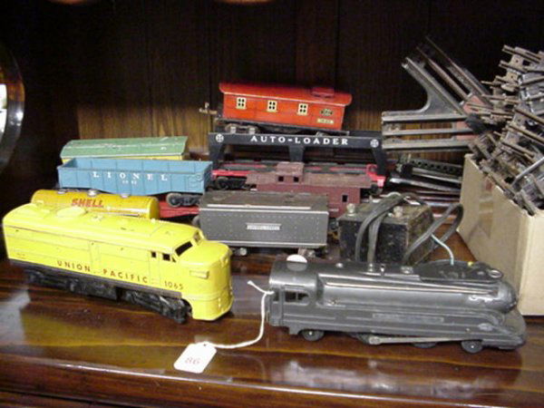 Lionel Train Cars and Tracks: 86. Lionel Train Cars and Tracks: Lionel 027 Scale 1688E Engine, Union Pacific 1065 Engine, Shell 1680 Tanker, 6042 Coal Car, 6812 Flat Car, 6079 Box Car, 1682 Caboose, 6414 Auto Loader, 6037 Caboose