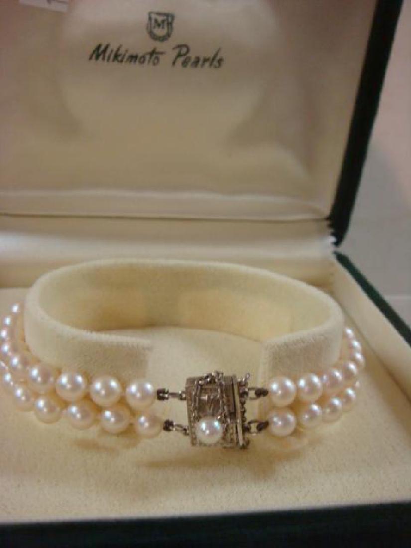 Double Strand of MIKIMOTO Akoya Pearl Bracelet:: Double Strand of MIKIMOTO Akoya Pearl Bracelet: 6 mm White South Sea Pearls in this 7" Long Bracelet. Signature Pearl Clasp with Safety Chain & 4 mm Pearl Marked M. Secured by Two Spacers. Total 62 Ha