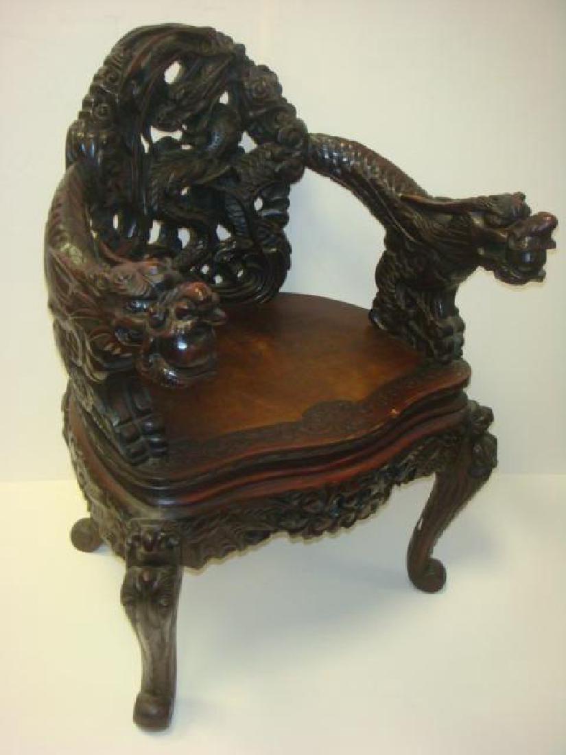 19th C Deeply Carved Japanese Dragon Throne Arm Chair:: 19th C Deeply Carved Japanese Dragon Throne Arm Chair: Meiji Dynasty Relief Carved Rosewood Arm Chair is Profusely Sculpted with Undulating Dragon at Back. Scales Spine Arms are Supported by the Hydra