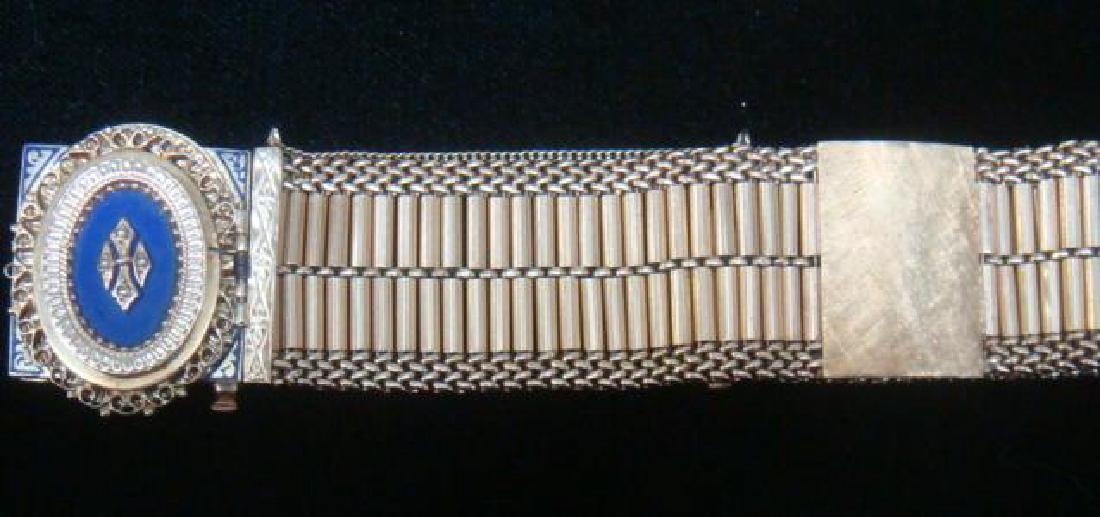 18 KT Victorian Inspired Bracelet Watch Convertible:: 18 KT Victorian Inspired Bracelet Watch Convertible: Gross Weight of 78.5 Grams, 7" in Length and 27 mm in Width. Hinge Opens to Expose 17 Jewel 5AF BULOVA Mechanical Watch. Hinge Set With Lapis Lazul