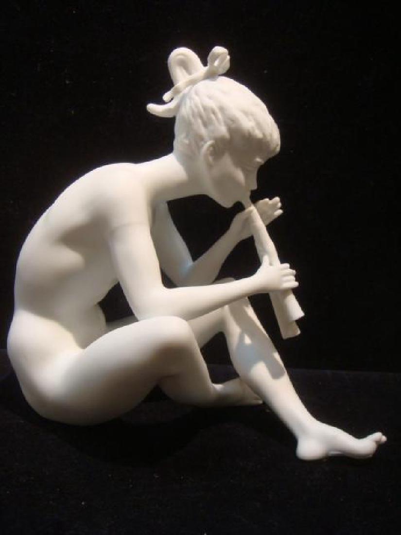 KAISER White Bisque Porcelain Nude Statue #385:: KAISER White Bisque Porcelain Nude Statue #385: Young Nude Girl Sitting and Playing Reeded Flute. German Piece has Matte Finish and is 7 1/2"T and 9"W. (100-150)