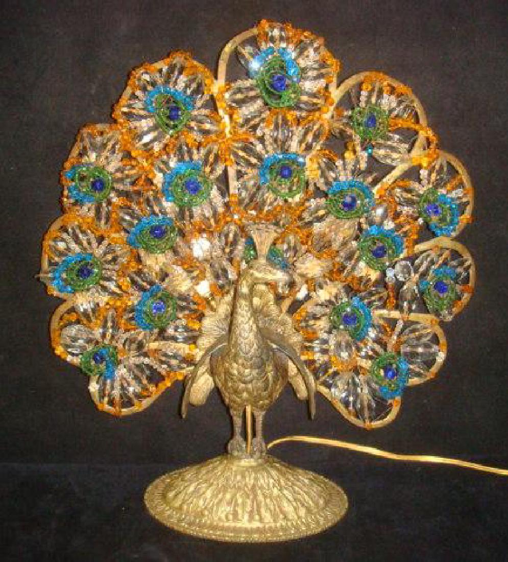 Art Deco Figural Czechoslovakia Jeweled Peacock Lamp:: Art Deco Figural Czechoslovakia Jeweled Peacock Lamp: Gilt Metal Bird Standing on Oval Embossed Foot with Metal Frame. Fanning Tail Feathers in Colorful Blue, Amber, Clear and Green Faceted Beads Stru