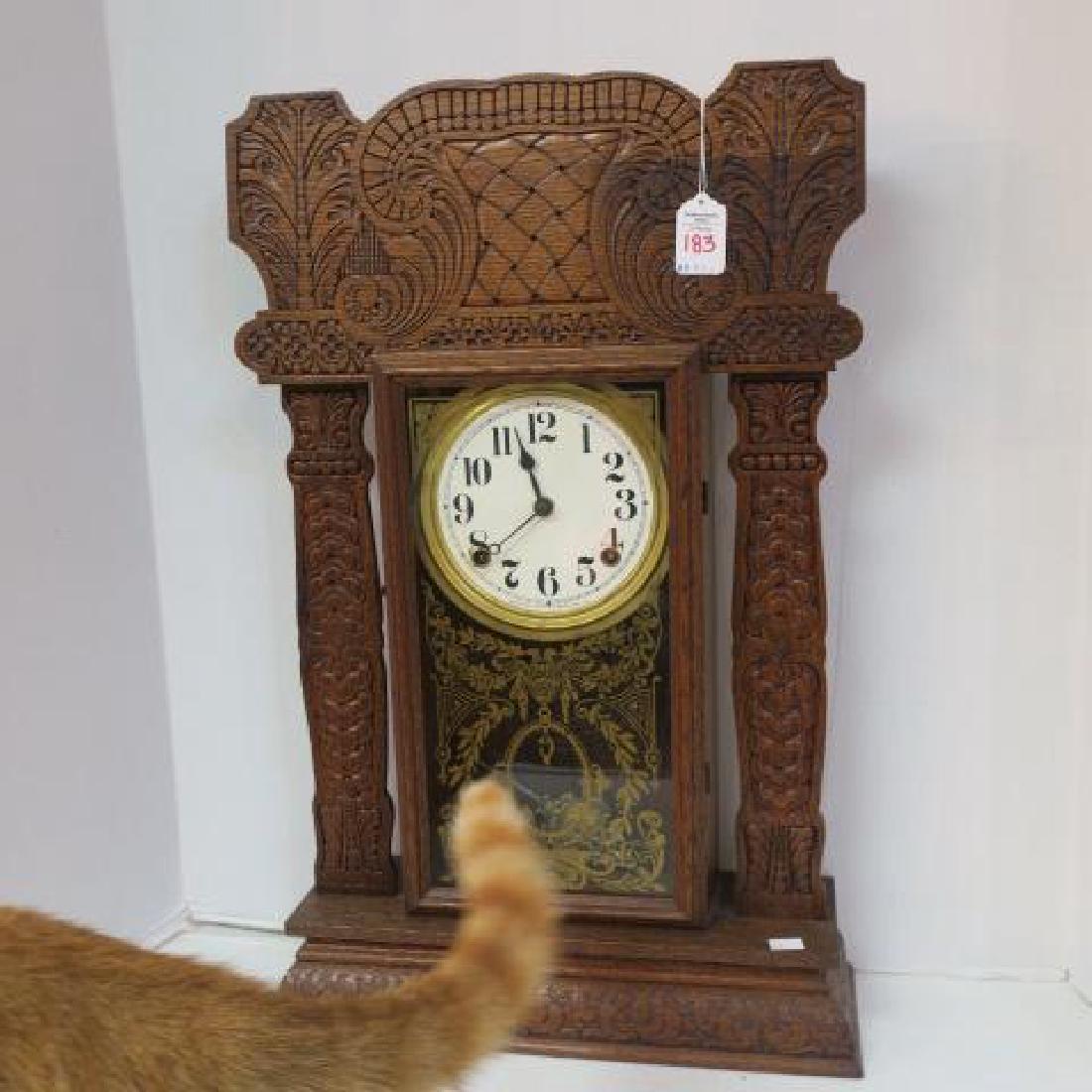 Circa 1880 INGRHAM Oak Gingerbread Clock:: Circa 1880 INGRHAM Oak Gingerbread Clock: 8 Day Key Wind with Key and Pendulum. Hand Carved Case with Flat Side Columns. Original Reverse Painted Gold Door. White Face with Roman Numerals and Spade Ha