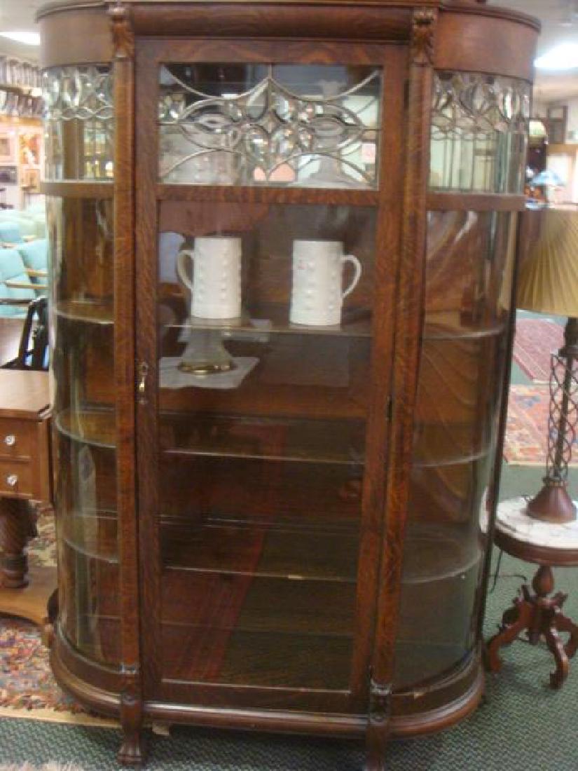 Dark Oak Curved Panel China Cabinet with Leaded Glass:: Dark Oak Curved Panel China Cabinet with Leaded Glass: Single Front Door Framed in 1/2 Round Molding with Carved Corbels and Flanked by Curved Glass Panels on Either Side (One Missing, Replaced by Ple