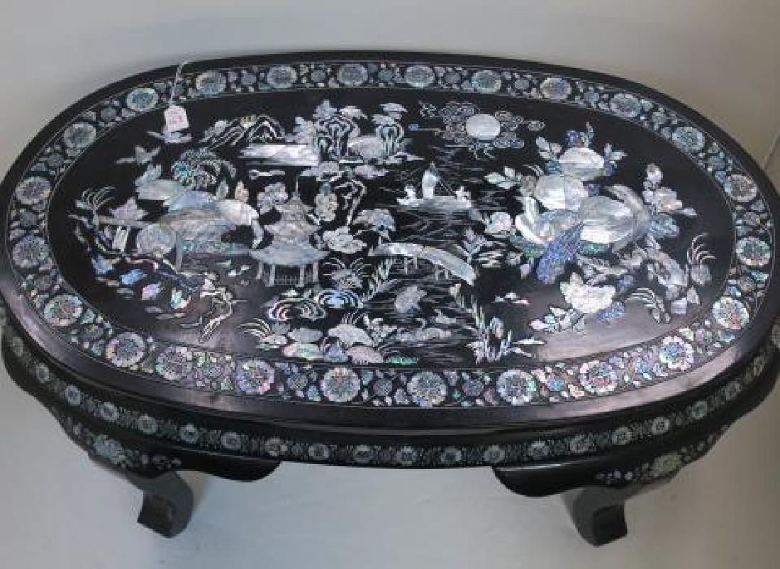 Black Oval Mother of Pearl Inlaid Tea Table:: Black Oval Mother of Pearl Inlaid Tea Table: Black Lacquered Table with Inset Mother of Pearl Scenes, Birds and Florals. 18"T, 41" X 25". Abundant Cut Mother of Pearl Pictorials. (300-600)