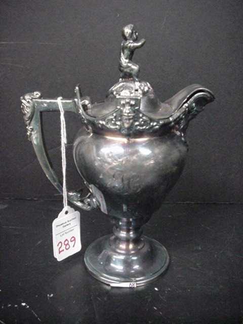 Silver Plate Presentation Piece and Creamer: Silver Plate Presentation Piece and Creamer: 1940 F.H.C. Dog Show Mug with German Shepherd Top, 5"T. Also Meriden Hinged Top Creamer with Faces on Sides and Handle. Boy Finial on Top Has Broken Arm, 8