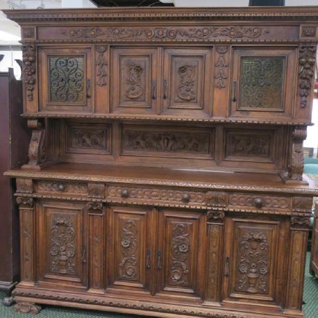 Lavishly Carved Belgian Two Piece Sideboard:: Lavishly Carved Belgian Two Piece Sideboard: Featuring Dolphins, Flowers and More. Superstructure with Four Cabinets, Two with Glass and Floral Iron overlay. Large Scroll Carved Supports. Lower Sectio