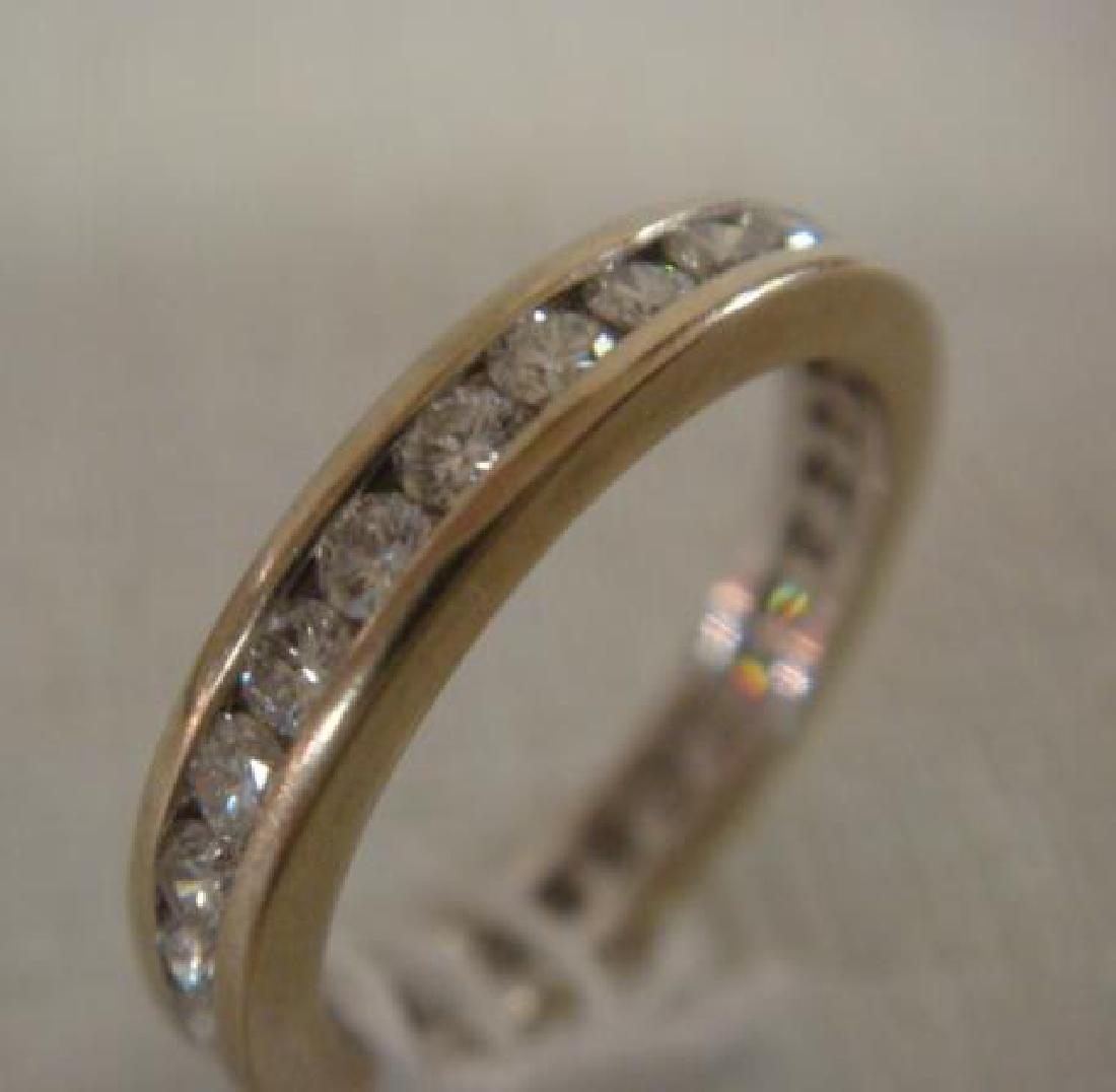 14 KT White Gold Band Ring with Channel Set Diamonds:: 14 KT White Gold Band Ring with Channel Set Diamonds: Estimated Total Weight of 29 Brilliant Cut Round Diamonds is 1 CT, Color G thru H Clarity SI1. Gross Weight of the Ring is 1.73 Pennyweights. With