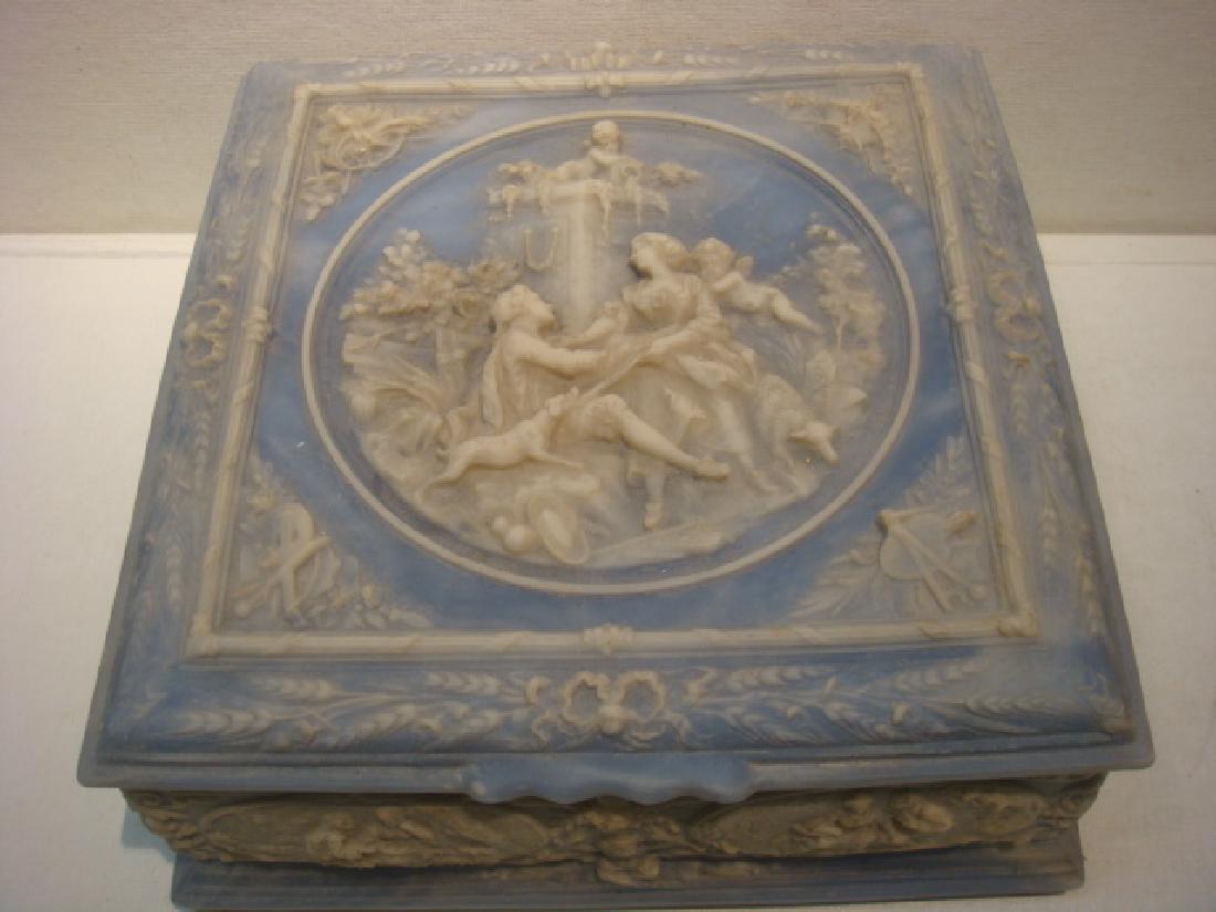Blue Incolay Stone Covered Jewelry Box:: Blue Incolay Stone Covered Jewelry Box: Marble Like Composition with Ivory Romantic Scene in the Style of Fragonard done in Relief on Hinged Lid with Medallions around Sides. Velvet Lined Fitted Inter