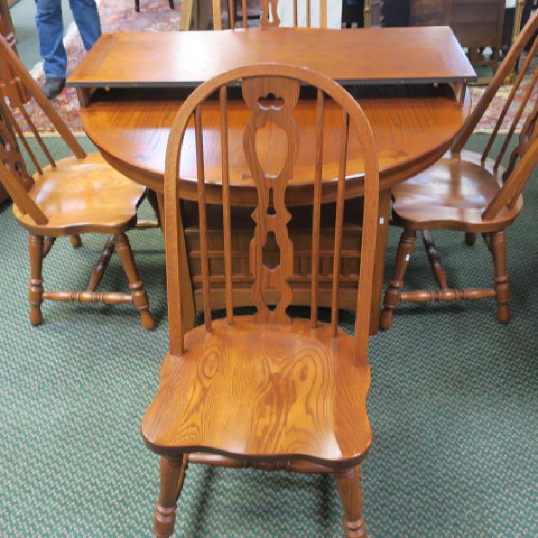 RICHARDSON BROTHERS Oak Dining Table and 4 Chairs:: RICHARDSON BROTHERS Oak Dining Table and 4 Chairs: Round Drum Table with Contrast Butterfly Dovetail Joinery at Top. Accompanied by Four Hoop Back Dining Chairs with Spindle Supports. (500-800)