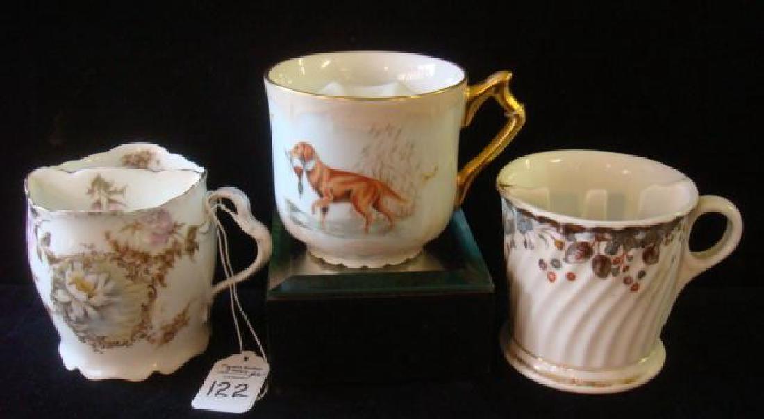 Three Vintage Ceramic Mustache Cups:: Three Vintage Ceramic Mustache Cups: One with Hunting Dog/Duck Prey (Unmarked). One with Flowers & Foliage (unmarked), One with Flowers and Lake, Marked R C with Crown (Philip Rosenthal & Co. 1901-194
