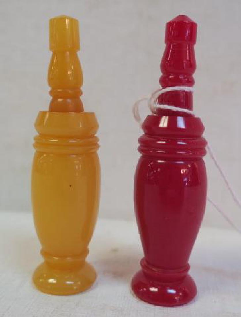 Two 1940's Turned Bakelite Perfume Bottles:: Two 1940's Turned Bakelite Perfume Bottles: Butterscotch and Red Baluster Form Bottles are 2 7/8"T. Tops Screw Off and Have a Bone Dauber. (100-200)