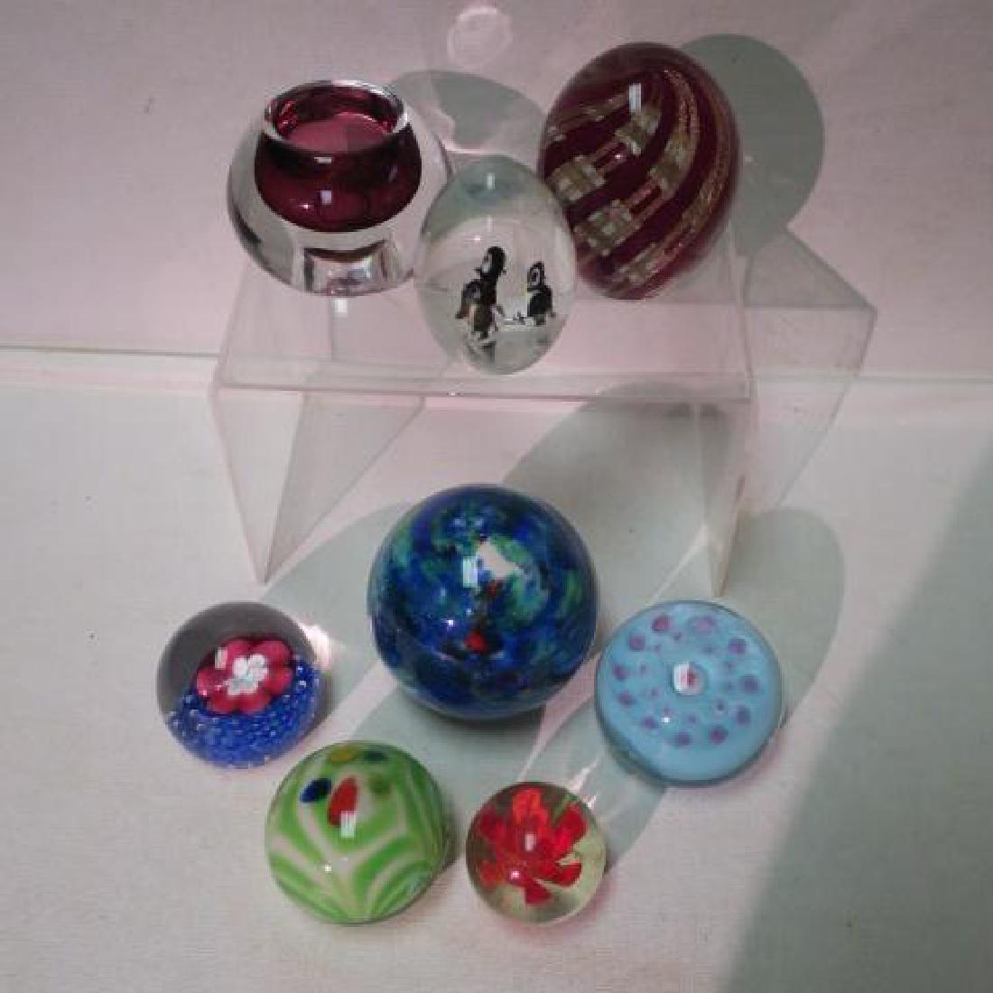Eight Art Glass Paperweights: Eight Art Glass Paperweights 3" Tall Red and Gold Swirl Egg shaped, 3 1/4" Blue & Green Cloud, 2 7/8" Tall Egg With Three Penguins inside. Red Hued Candleholder Globe Paperweight. Two Flower Themed, P