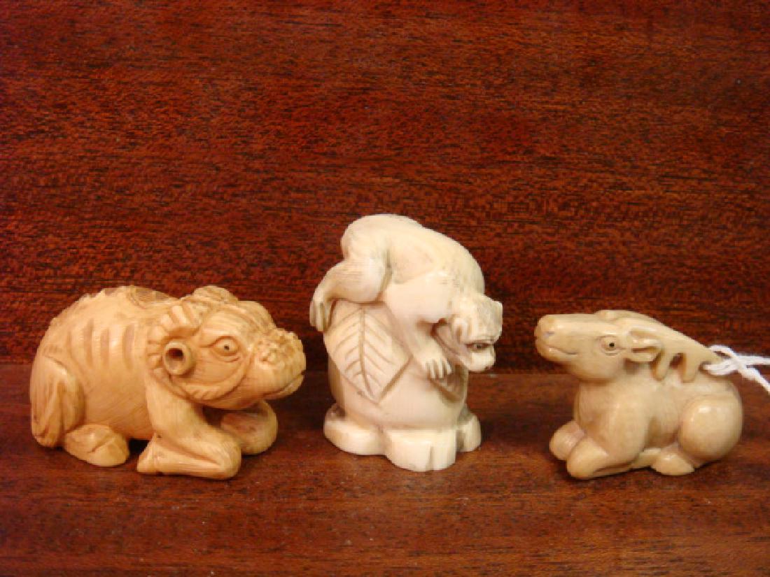 Three Animal Netsukes:: Three Animal Netsukes: Includes Monkey Lying on Fruit, Reclining Deer and Reclining Horned Animal. All Signed. These Netsukes are only for Sale in the Commonwealth of Virginia and will NOT be sold Int